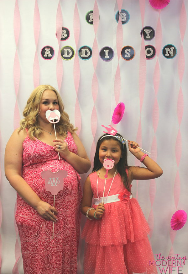 A photo booth for a baby shower is a great baby shower idea! Print out the pictures for your guests and send them with their thank you card!