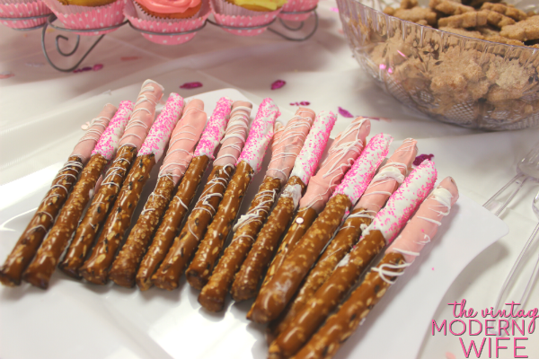 These pink chocolate covered pretzel rods are perfect for a pink baby shower for a girl!