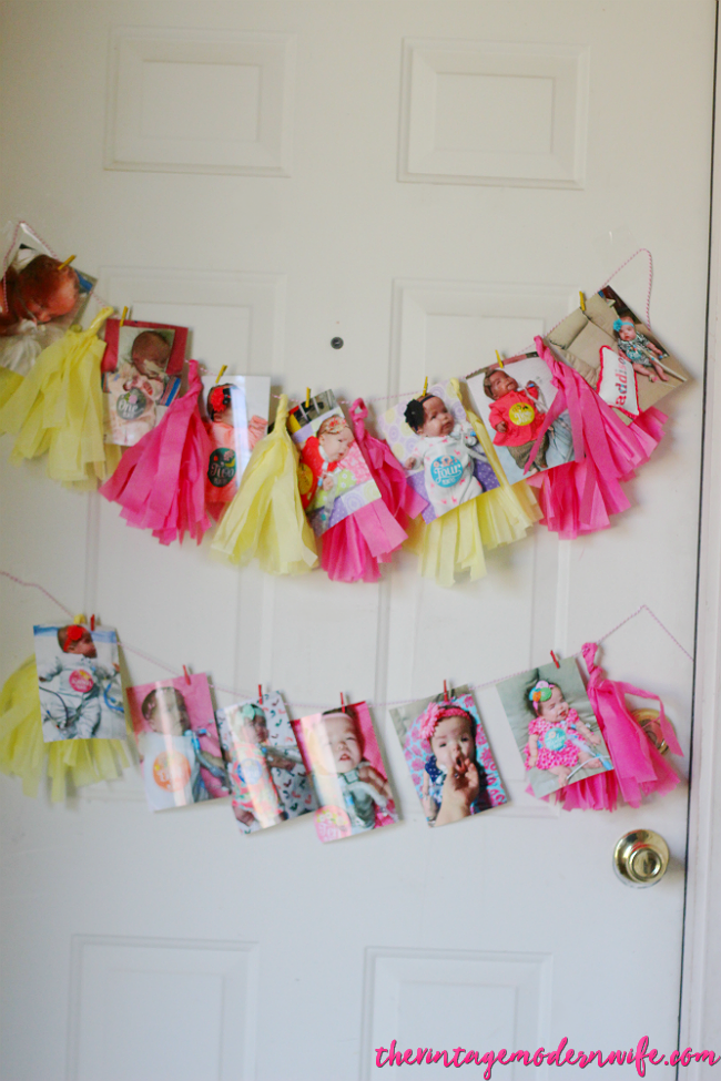 Love this birthday banner with monthly pictures of their baby for her lemonade first birthday party! What a cute idea for the door!